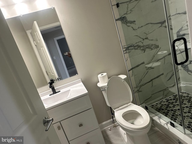 bathroom featuring vanity, toilet, and an enclosed shower