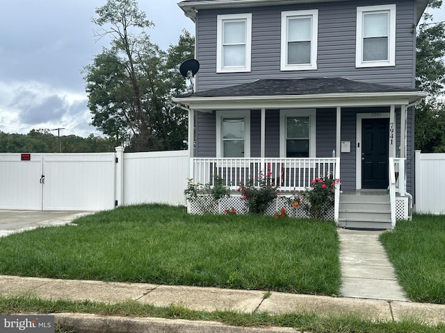 view of front of home with a front yard and a porch