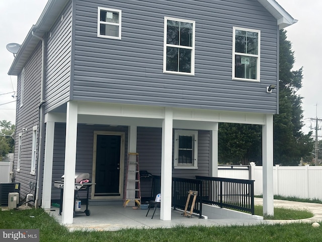 rear view of house with covered porch and central air condition unit