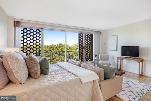 bedroom featuring access to outside and light hardwood / wood-style flooring