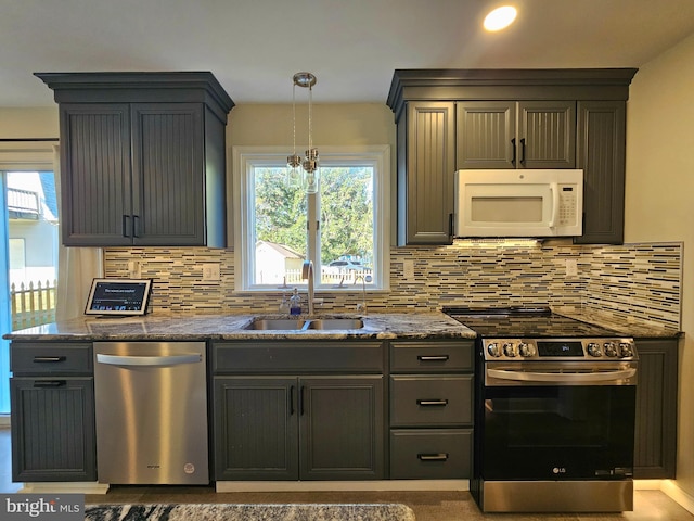 20826 Bivalve Wharf Rd, Bivalve, MD 21814 - kitchen with tasteful backsplash, appliances with stainless steel finishes, a sink, and dark stone countertops