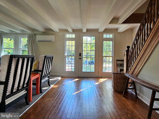 entryway with dark hardwood / wood-style flooring, a wall unit AC, french doors, and beamed ceiling