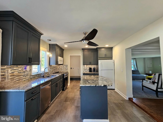 20826 Bivalve Wharf Rd, Bivalve, MD 21814 - kitchen featuring light stone counters, a ceiling fan, a kitchen island, stainless steel appliances, and a sink