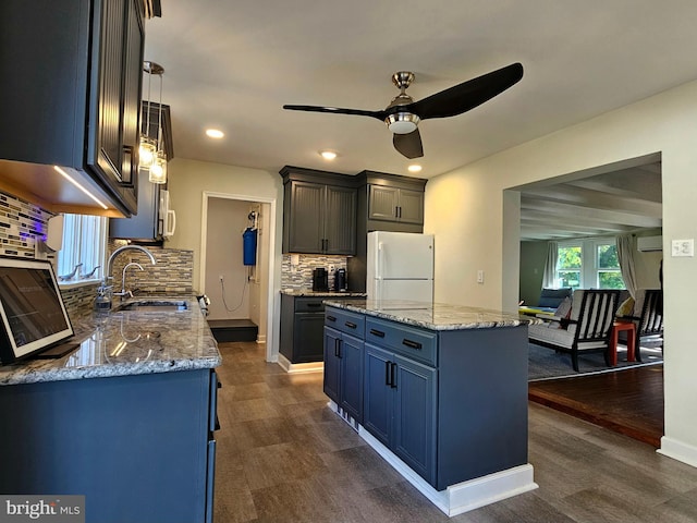 20826 Bivalve Wharf Rd, Bivalve, MD 21814 - kitchen featuring freestanding refrigerator, light stone countertops, a ceiling fan, a center island, and backsplash