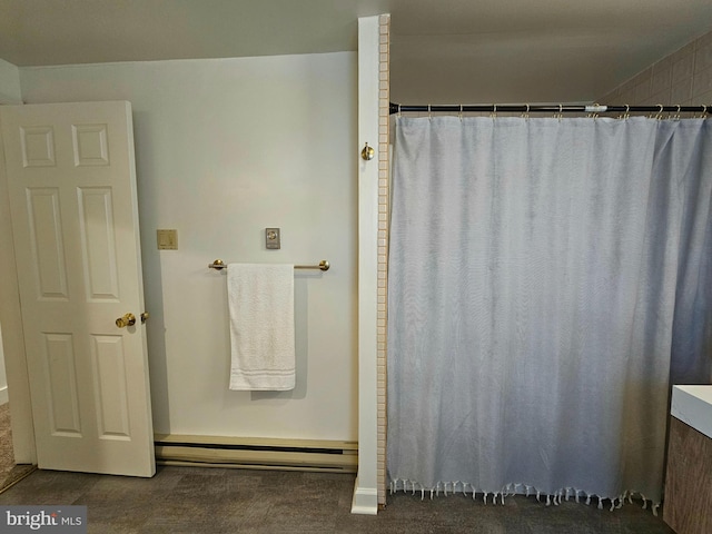 bathroom with curtained shower and baseboard heating