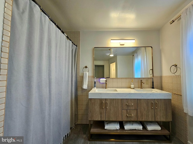 bathroom with vanity and tile walls