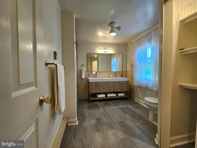 bathroom with vanity, toilet, wood-type flooring, and decorative backsplash