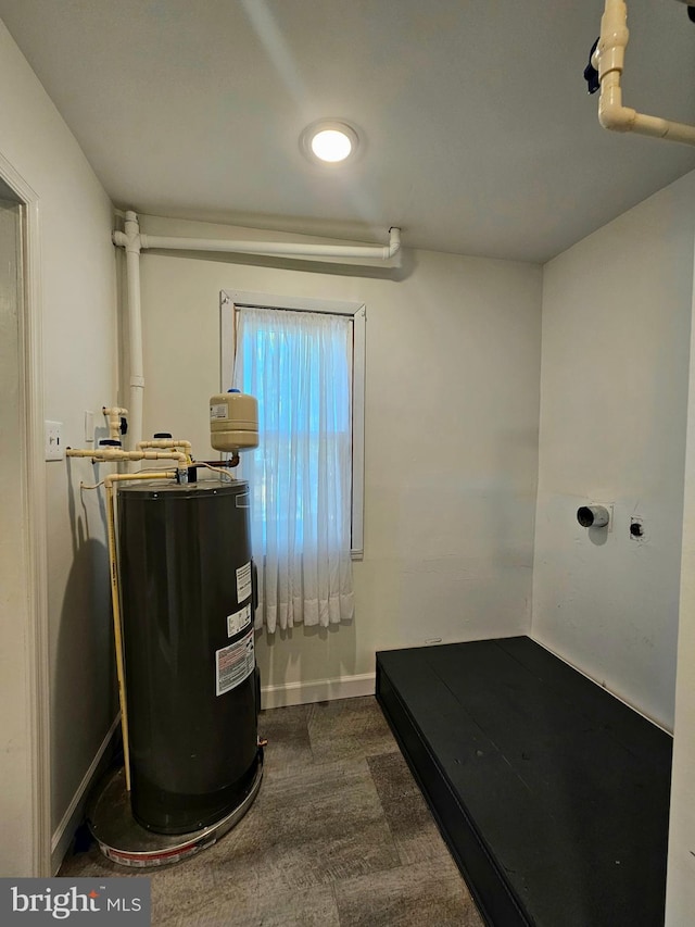 20826 Bivalve Wharf Rd, Bivalve, MD 21814 - interior space with water heater, baseboards, and dark carpet