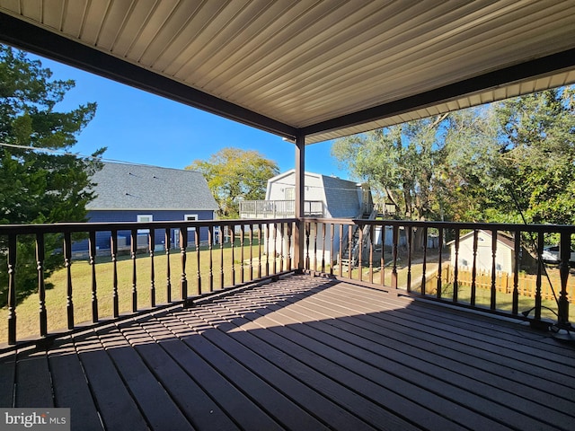 wooden terrace featuring a yard