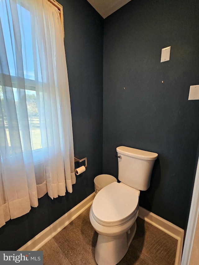 bathroom with a wealth of natural light and toilet