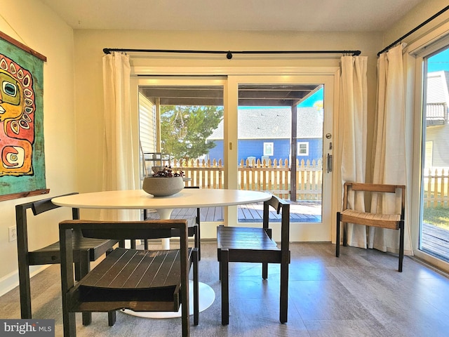 dining space with wood-type flooring