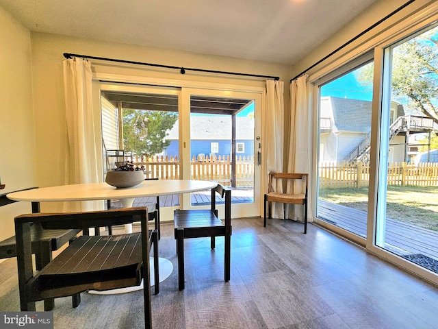 dining room with hardwood / wood-style flooring and a water view