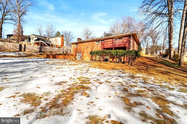 view of snowy exterior with a deck