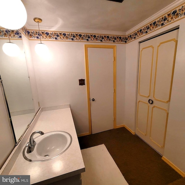 bathroom with vanity and ornamental molding