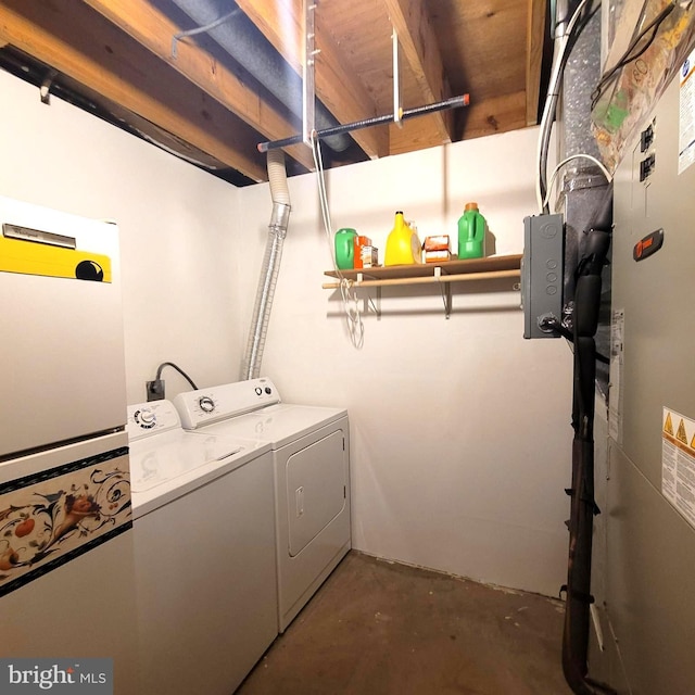 laundry area with heating unit and washer and clothes dryer