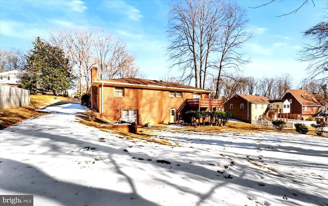 view of snowy exterior with a deck