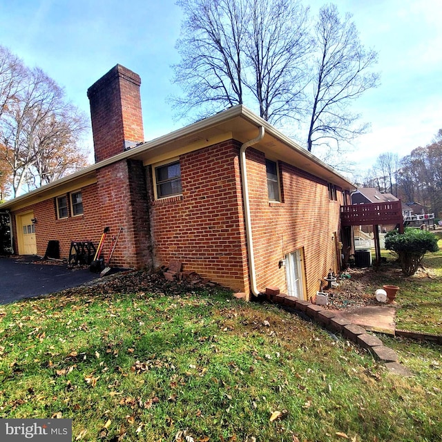 view of home's exterior featuring a yard and central air condition unit