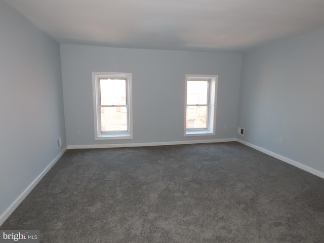 carpeted spare room with plenty of natural light