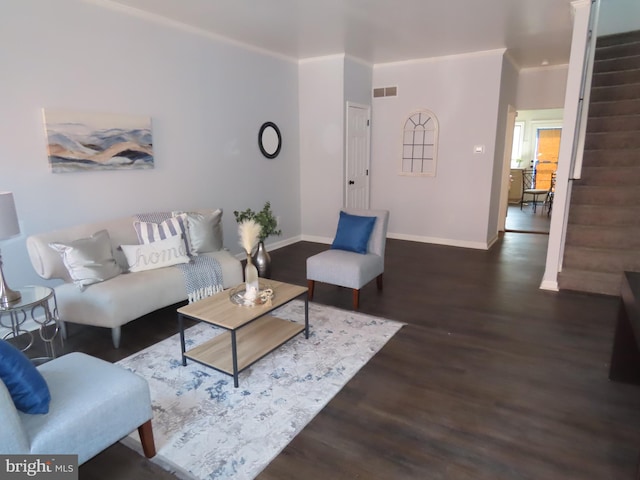 living room featuring ornamental molding and dark hardwood / wood-style flooring