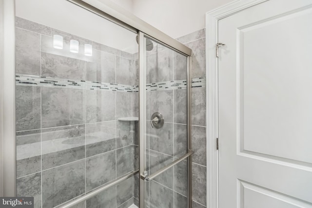 bathroom featuring a shower with door