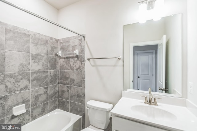 full bathroom featuring vanity, tiled shower / bath combo, and toilet