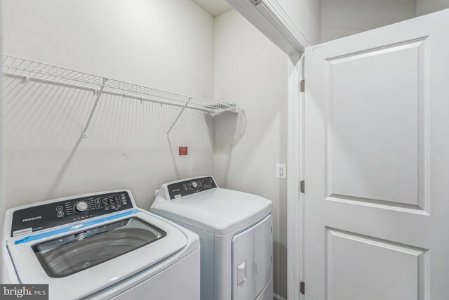 clothes washing area with washing machine and clothes dryer