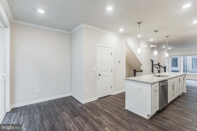 kitchen featuring hanging light fixtures, sink, a center island with sink, white cabinetry, and light stone countertops