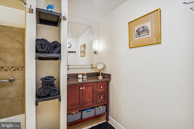 bathroom featuring vanity, plus walk in shower, and tile patterned flooring