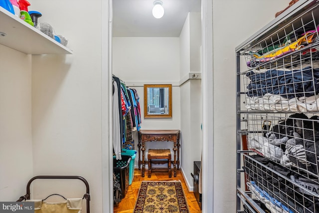 spacious closet with parquet flooring