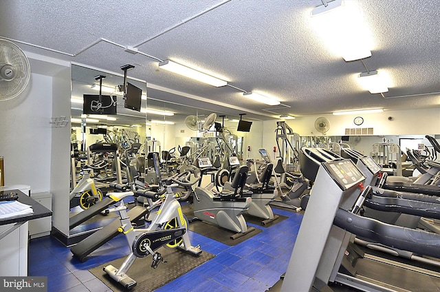 gym featuring a textured ceiling