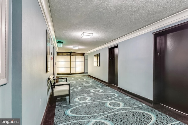 corridor with crown molding and a textured ceiling