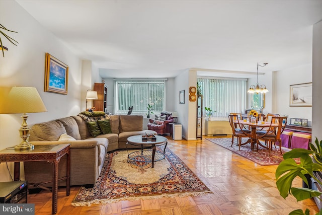 living room with light parquet flooring and a chandelier