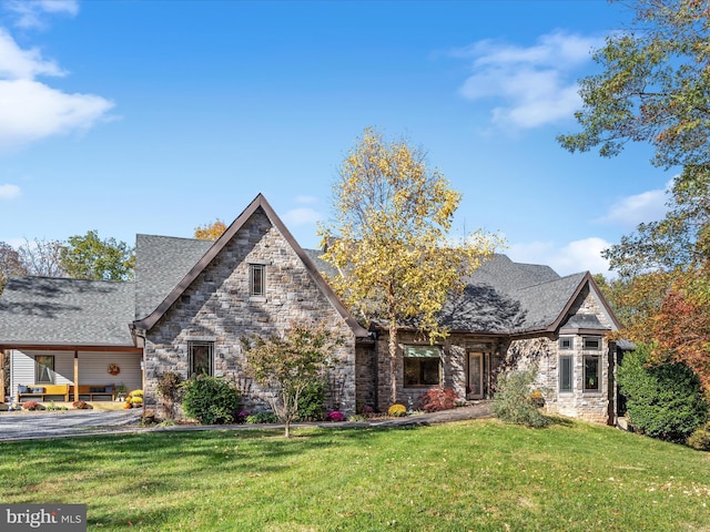 tudor home with a front yard