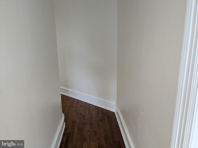 hallway with dark hardwood / wood-style floors