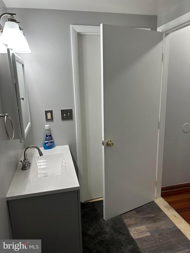 bathroom with vanity and hardwood / wood-style flooring