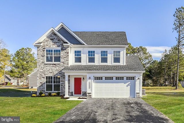 view of front of property featuring a front lawn and a garage