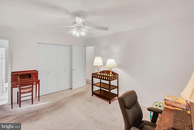 office featuring light carpet and ceiling fan