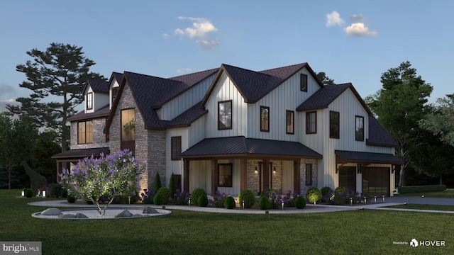 modern farmhouse featuring covered porch and a front yard