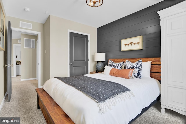 bedroom with wooden walls and carpet