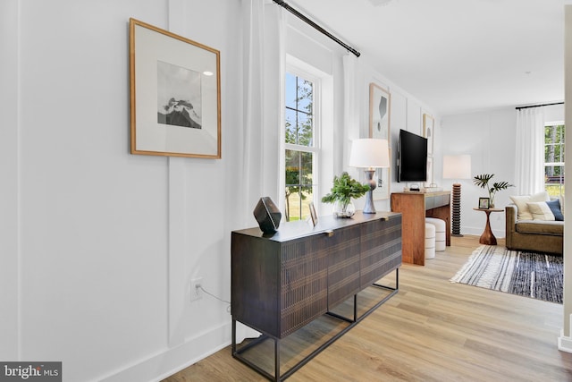 living room featuring plenty of natural light and light hardwood / wood-style floors