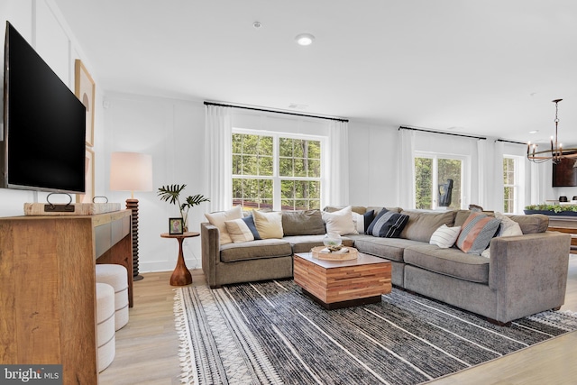 living room with wood-type flooring and a notable chandelier