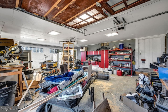 garage featuring a garage door opener and a workshop area