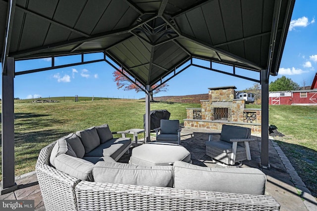 view of patio with a gazebo, an outdoor living space with a fireplace, and a grill