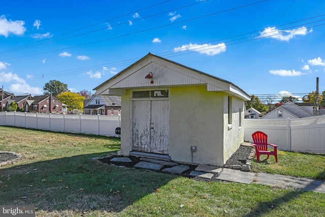 view of outbuilding featuring a yard