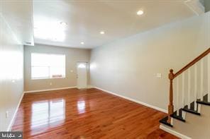 unfurnished room featuring hardwood / wood-style flooring