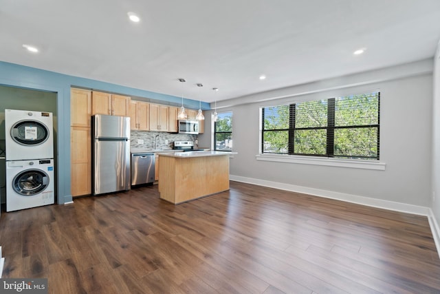 kitchen with appliances with stainless steel finishes, a center island, dark hardwood / wood-style floors, and hanging light fixtures