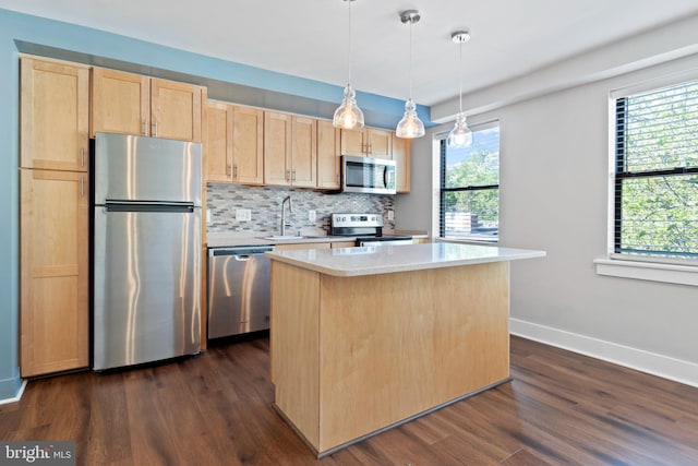 kitchen with light brown cabinetry, a kitchen island, stainless steel appliances, and dark hardwood / wood-style flooring