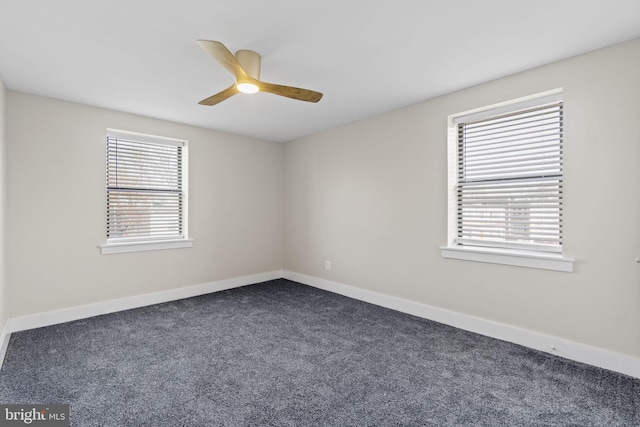 carpeted spare room featuring ceiling fan