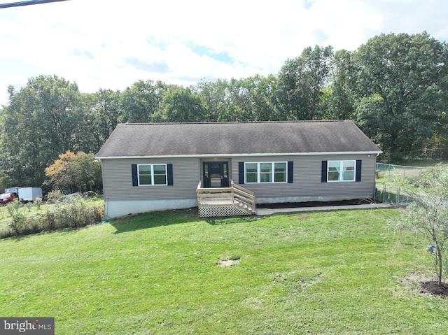 view of front of home featuring a wooden deck and a front yard