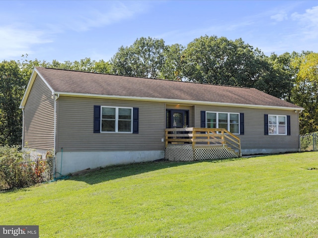 view of front of home featuring a wooden deck and a front lawn